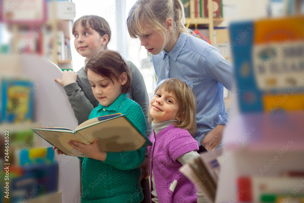 girls with book between shelves in library. girls with book between shelves in library.