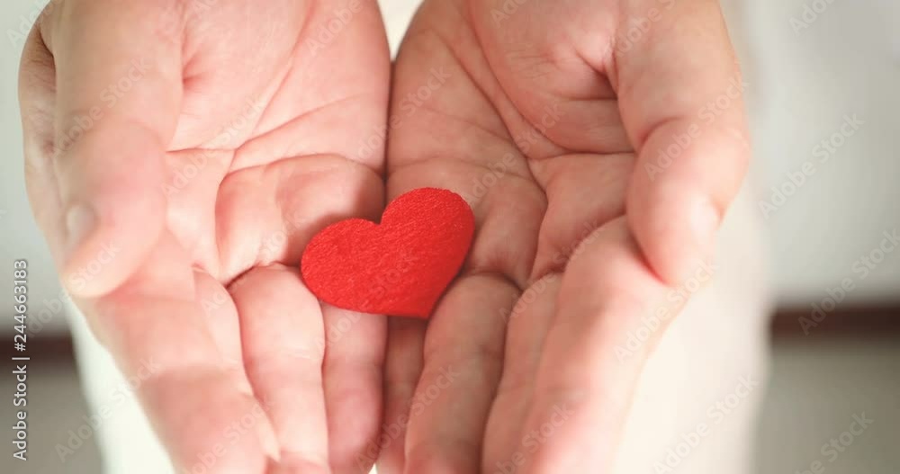 A man holding and giving  heart shape , love romance , take care health and family , Love giving of Happy Valentine's Day or anniversary concept , 4K Dci resolution