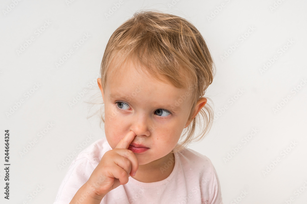 Baby girl is picking her nose with finger inside Baby girl is picking her nose with finger inside