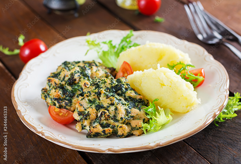 Baked steak chopped chicken fillet with spinach and a side dish of mashed potatoes. European cuisine. Dietary food. Baked steak chopped chicken fillet with spinach and a side dish of mashed potatoes. European cuisine. Dietary food.