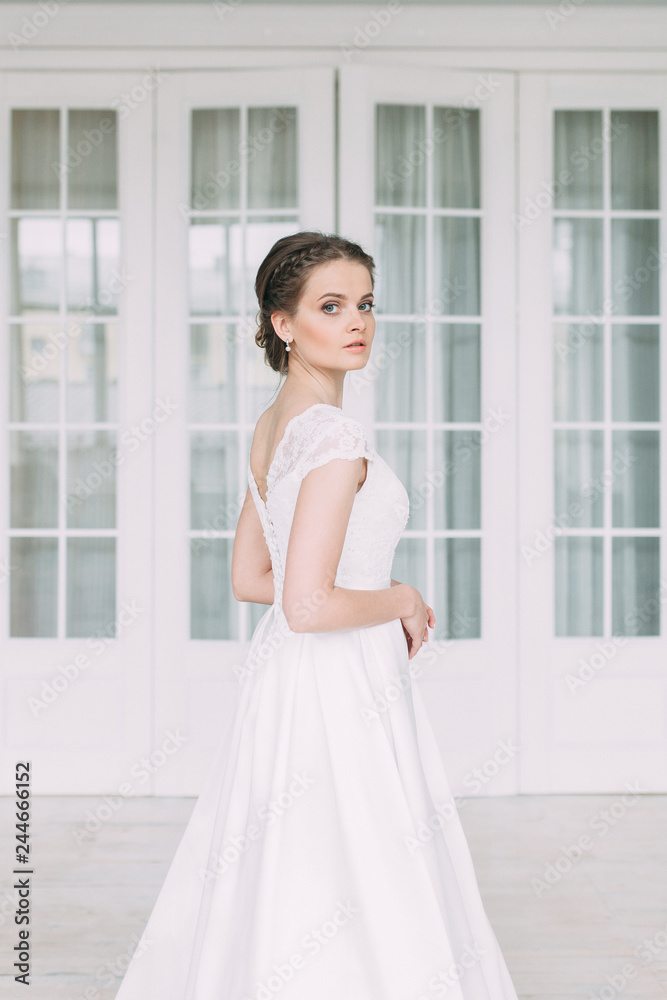 The bride in the white Studio with a bouquet. Wedding in the European style fine art. The bride in the white Studio with a bouquet. Wedding in the European style fine art.