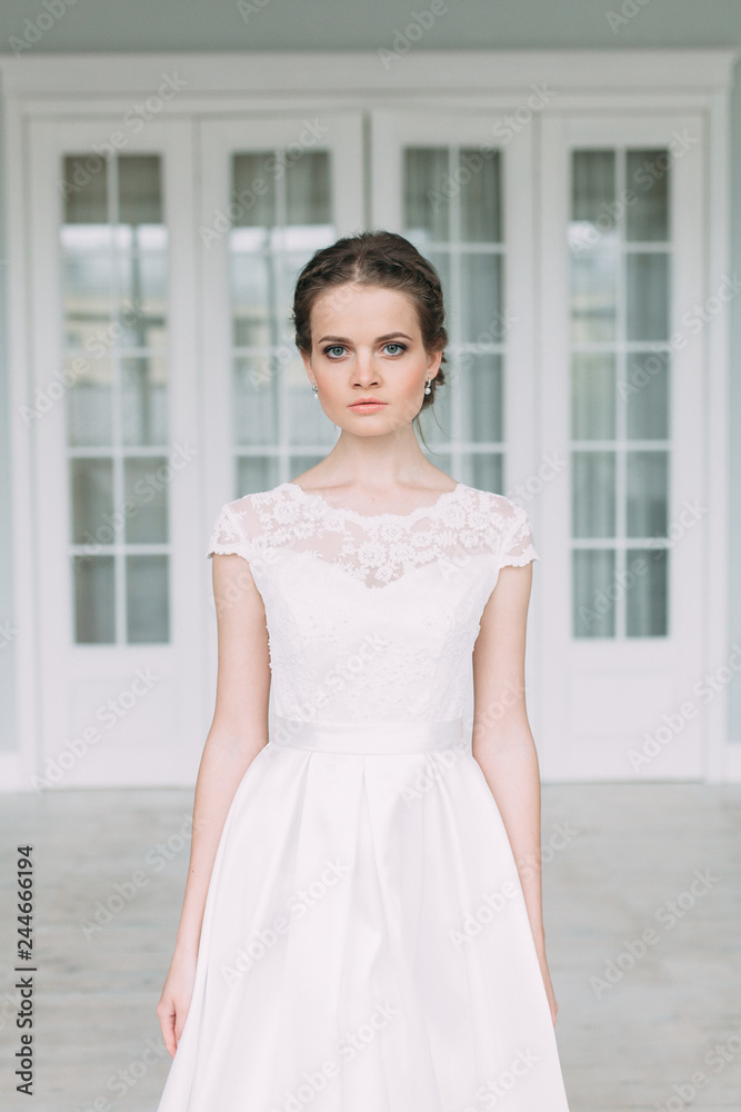 The bride in the white Studio with a bouquet. Wedding in the European style fine art. The bride in the white Studio with a bouquet. Wedding in the European style fine art.