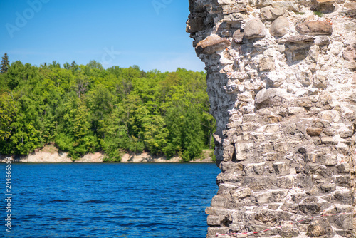 Ancient fortress or castle ruins close to the river or lake.  photo