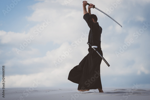 Man training martial arts in desert photo