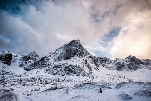 Fantastic snowy mountain range with cloudy sky