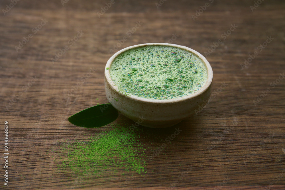 matcha green tea in a bowl on a dark background matcha green tea in a bowl on a dark background