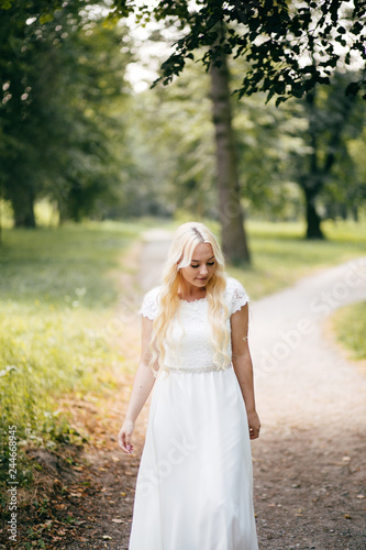 portrait of a young woman in a white dress outdoors