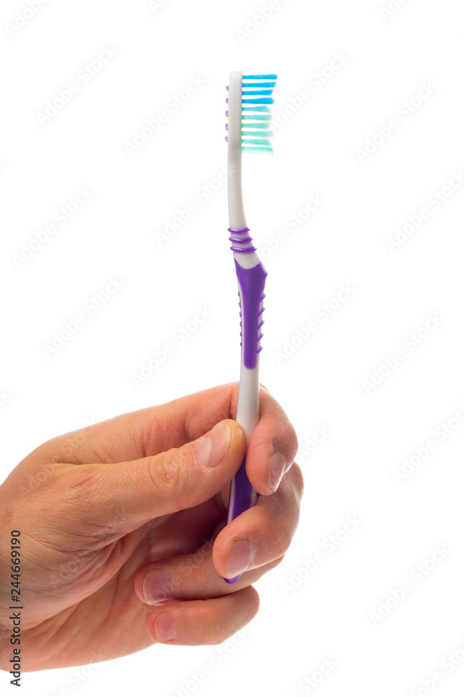 toothbrush in hand on an isolated background toothbrush in hand on an isolated background