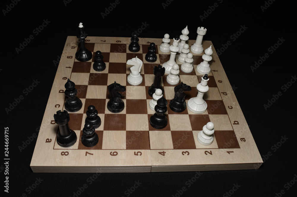 Chess board under black pieces like a sport concept Chess board under black pieces like a sport concept