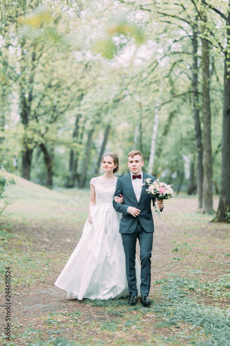 Beautiful young couple in the atmospheric forest. Wedding in the European style fine art.