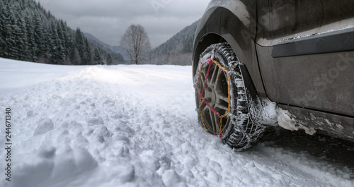 Snow chains on tire at winter road © Jaroslav Moravcik