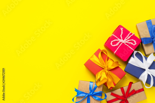 A lot of gift boxes on a yellow background. Holiday concept, New Year, Christmas, Birthday, Valentine's Day. Flat lay, top view.
