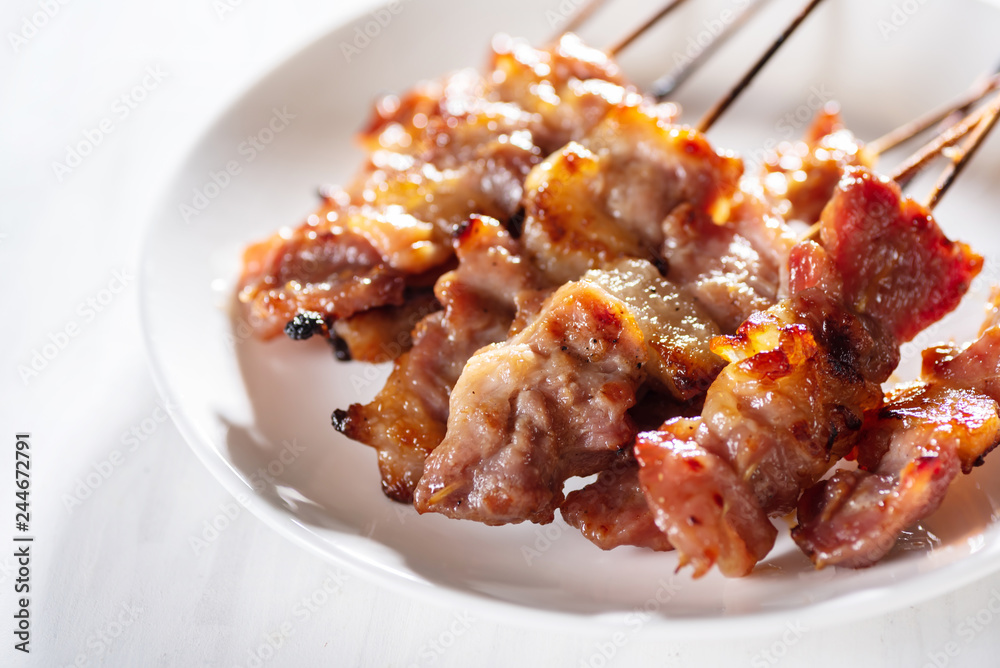 Grilled pork with bamboo stick, poppular street Thai food Grilled pork with bamboo stick, poppular street Thai food