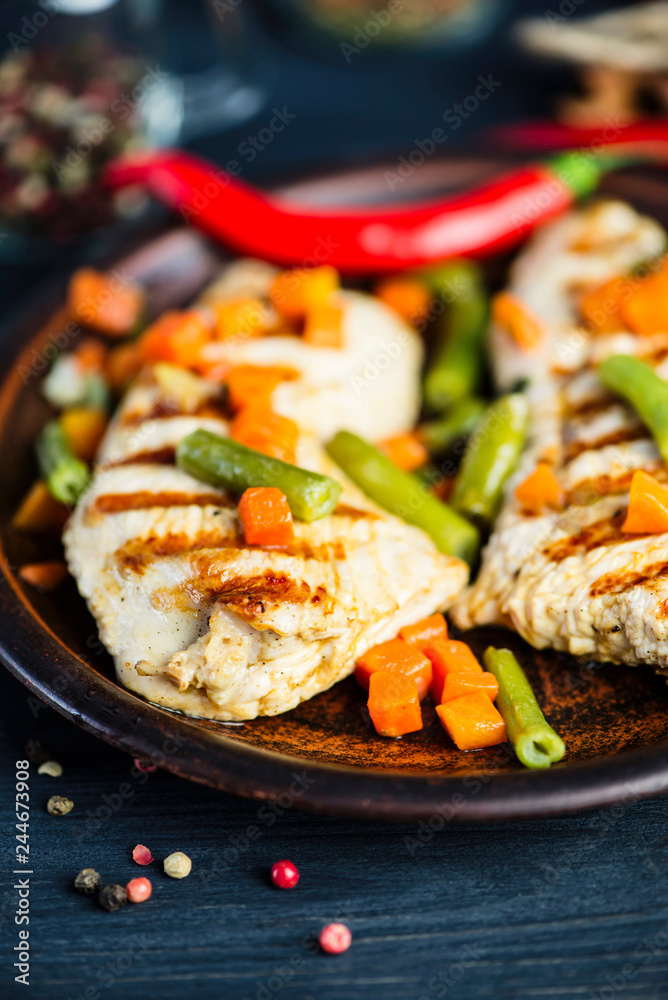 grilled turkey fillet with vegetables, pepper and spices on a plate grilled turkey fillet with vegetables, pepper and spices on a plate