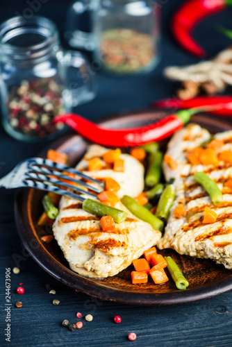 grilled turkey fillet with vegetables, pepper and spices on a plate