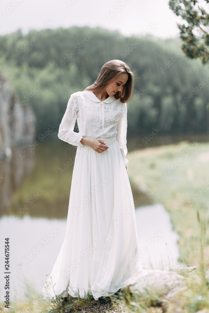 Morning bride on a beautiful panoramic location. Girl in boudoir dress and cliffs. Morning bride on a beautiful panoramic location. Girl in boudoir dress and cliffs.