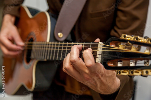 musician plays guitar close up