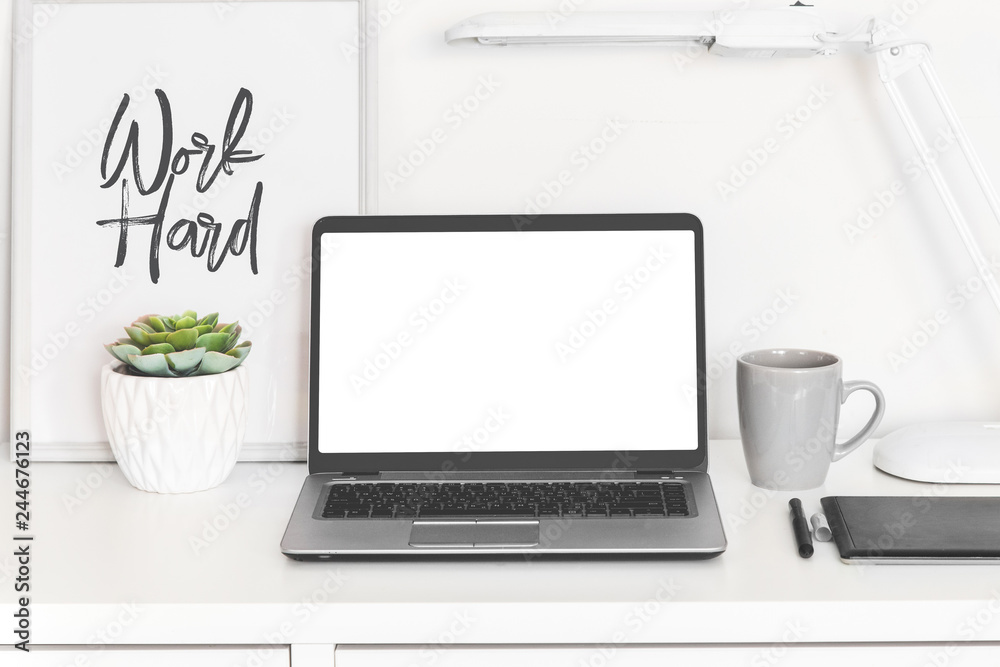 laptop-computer-white-blank-screen-on-work-table-front-view-office