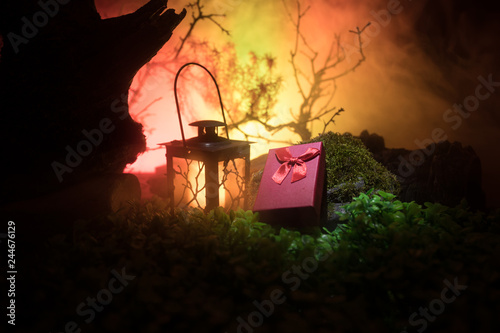 Night wedding ceremony with a lot of vintage lamps and candles on big tree