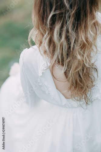 Boudoir morning bride in nature in a white dress. Wedding series on cliffs and river bends.