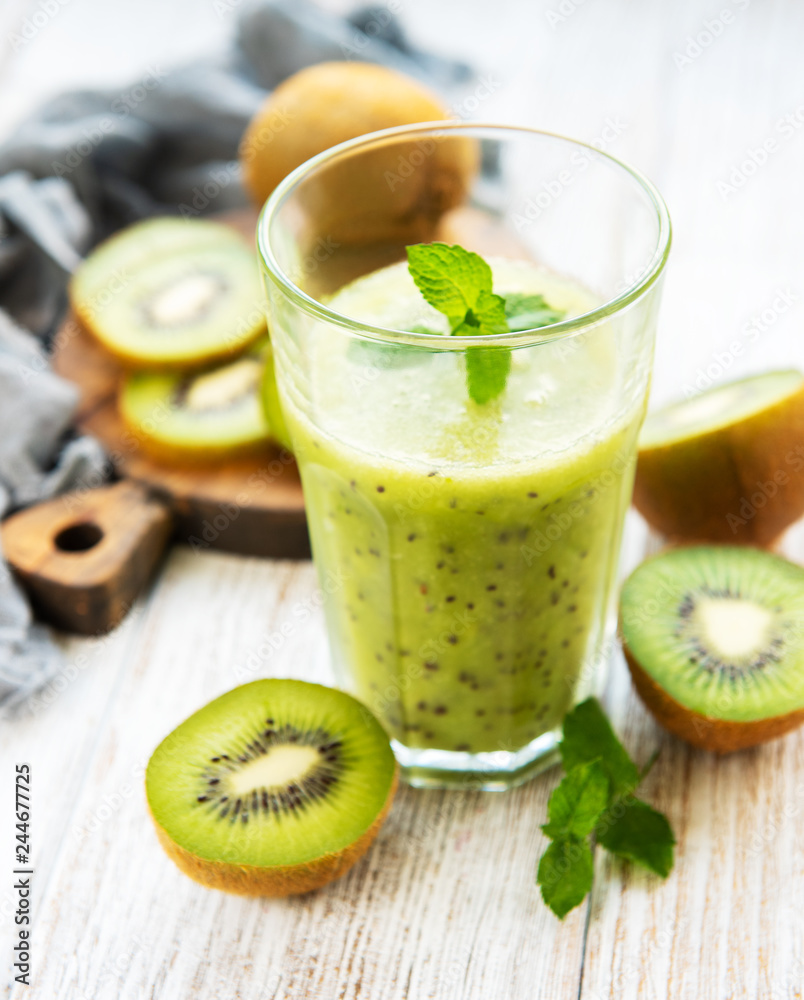 Glass of kiwi smoothie with fresh fruits Glass of kiwi smoothie with fresh fruits