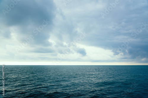 Cloudy evening sky over the sea surface of the water