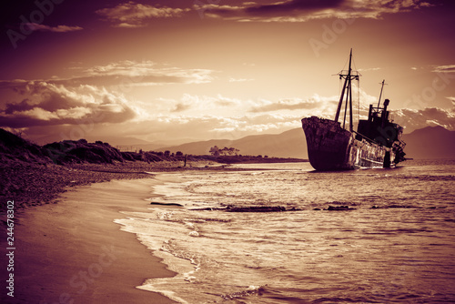 Rusty broken shipwreck on sea shore