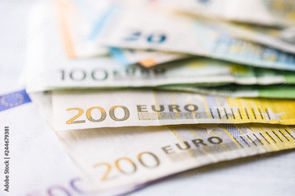 Two hundred euro banknotes in detail on the pile of other nominal banknotes. Two hundred euro banknotes in detail on the pile of other nominal banknotes.
