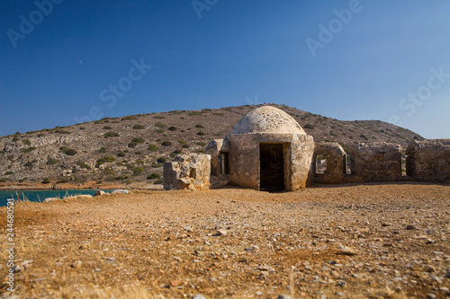 Fragment of a defense tower and walls in the Spinalonga fortress. Sea view from the leper island in Greece.