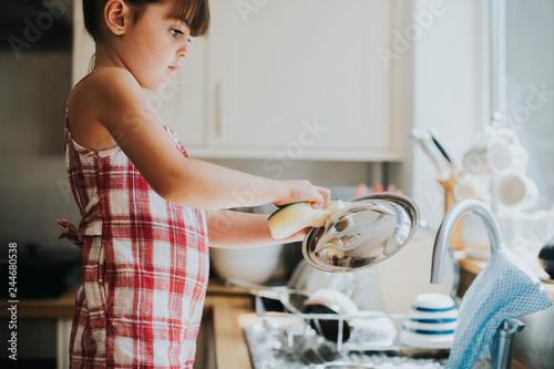 Little girl doing the dishes