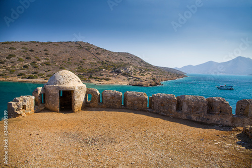 Fragment of a defense tower and walls in the Spinalonga fortress. Sea view from the leper island in Greece.