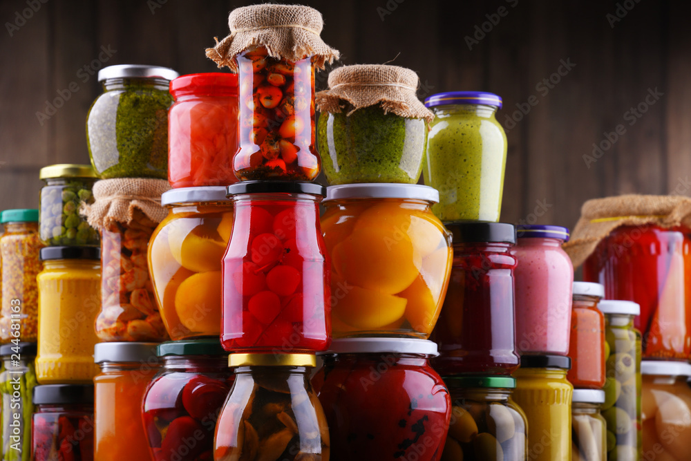 Jars with variety of pickled vegetables and fruits Jars with variety of pickled vegetables and fruits