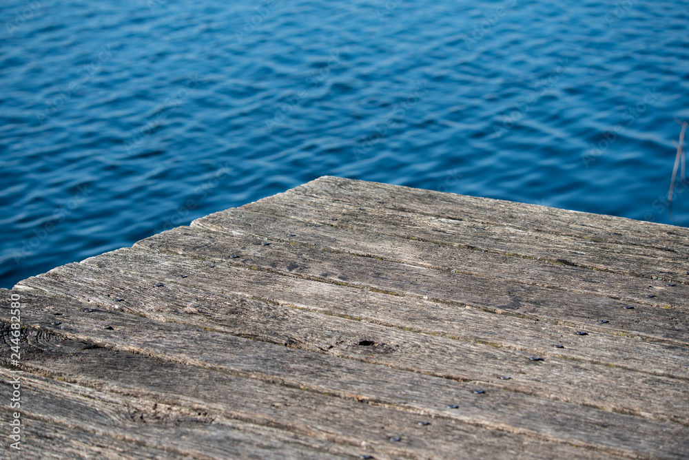 Corner of an old wooden pier by the lake