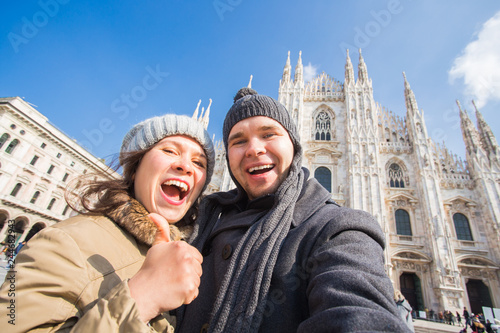Couple taking self portrait in Duomo square in Milan. Traveling and relationship concept