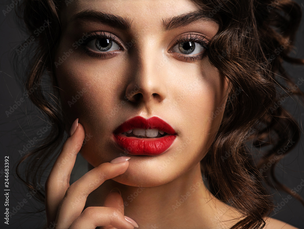 Face of a beautiful woman with a smoky eye makeup and red lipstick Face of a beautiful woman with a smoky eye makeup and red lipstick
