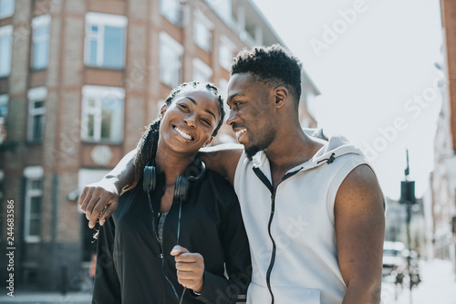 Happy athletic couple playing around while on a walk