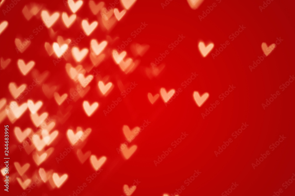 Valentine heart bokeh lights against a red background Valentine heart bokeh lights against a red background