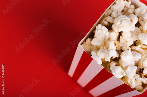 Photos Bucket of popcorn on red background