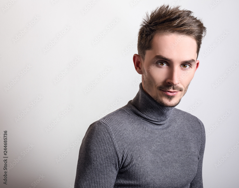 Handsome young elegant man in grey golf. Handsome young elegant man in grey golf.
