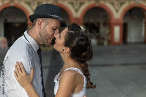 A vintage couple in love about to kiss in the street. © Javier Romera