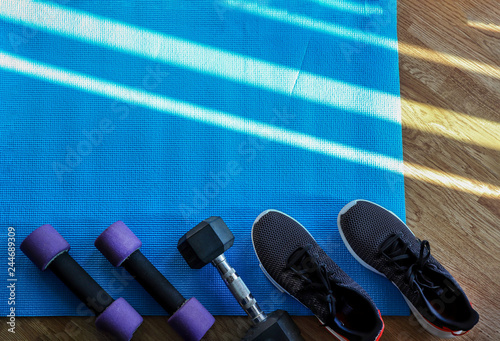 Fitness concept background with dumbbells and shoses on blue mat ,Top view with space for your text - Image - Image photo