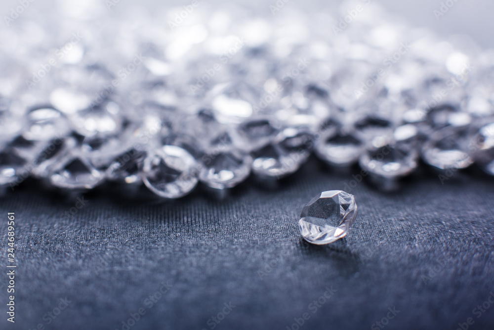 a scattering of artificial diamonds with bokeh on the background close-up a scattering of artificial diamonds with bokeh on the background close-up