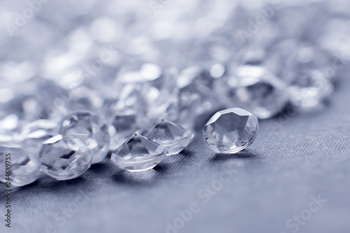 a scattering of artificial diamonds with bokeh on the background close-up