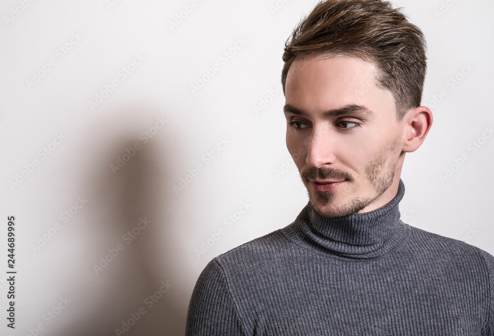 Handsome young elegant man in grey golf. Handsome young elegant man in grey golf.