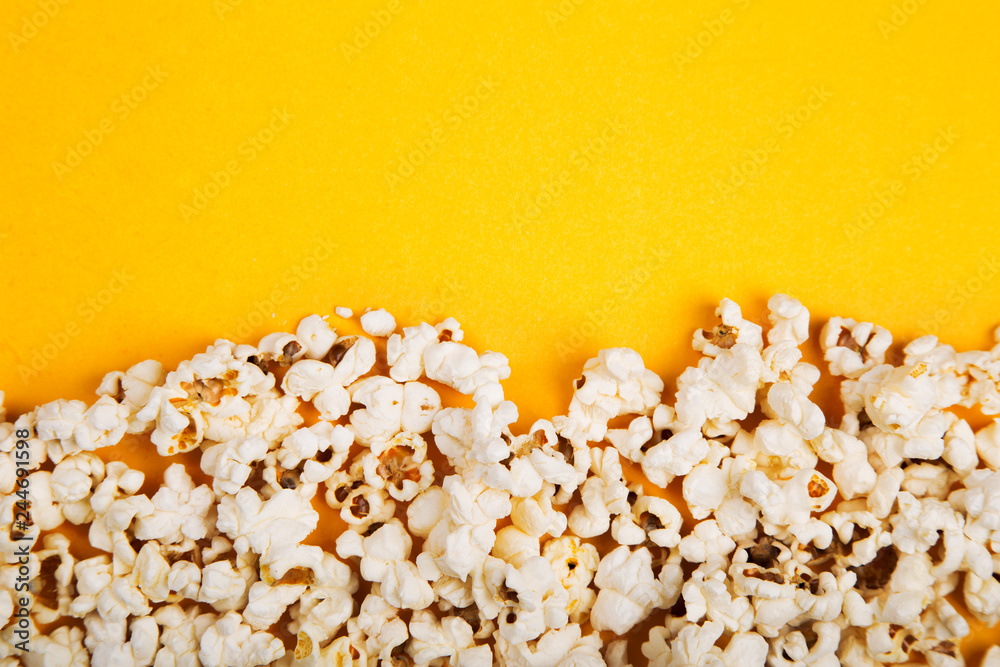 Popcorn on yellow background. Minimalism fashion detail Popcorn on yellow background. Minimalism fashion detail