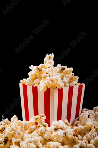 Box of fresh popcorn on black background
