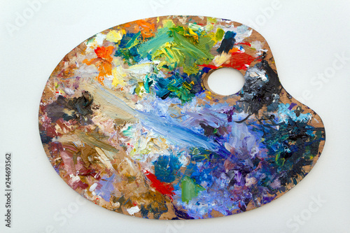 Vibrant multi-coloured artists oil or acrylic paints palette on textured white paper