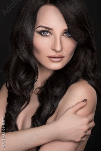 Portrait of a sexy brunette with an elegant hairstyle and evening makeup