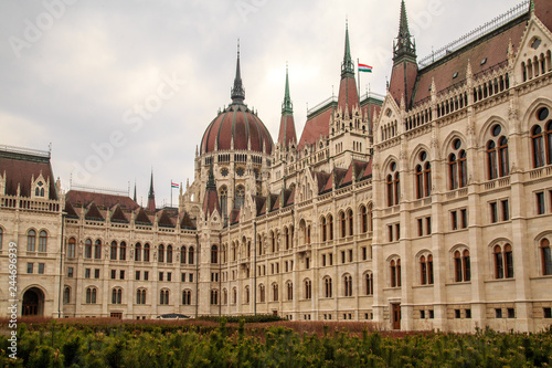 Daytime view of historical building of Hungarian Parliament, aka Orszaghaz, with typical symmetrical architecture and central dome on Danube River embankment in Budapest, Hungary, Europe © Ruslan Gilmanshin
