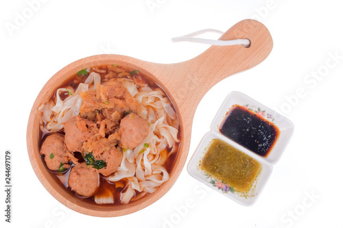 Delicious homemade Bakso, famous traditional Indonesian street food, meatballs with noodles served with chili saucel and soy sauce isolated on white background photo